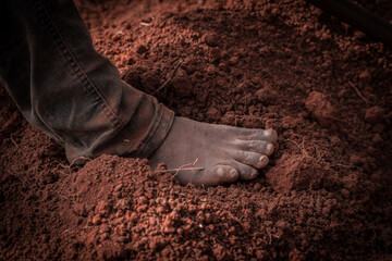 A black man's foot on the earth