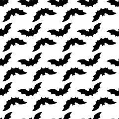 seamless black bat silhouette pattern for Halloween packaging design template. a soaring bat with pointed ears is drawn in a doodle style often on white