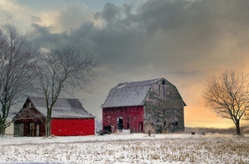 winter barn at sunset as the snow softly falls on this Michigan landscape 