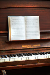 Old vintage piano with musical notes at a classical music festival. An antique wooden keyboard with...
