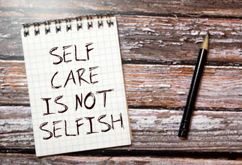 Dried pampas grass in vases, candles and felt letter board with phrase self care.