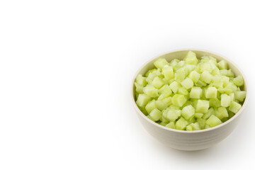 Chayote cubes in bowl isolated on white background.