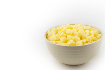 Raw potato cubes in bowl isolated on white background.