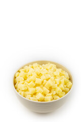 Raw potato cubes in bowl isolated on white background.