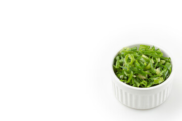 Sliced ​​scallion in ramekin isolated on white background.