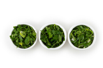 Sliced ​​cilantro, chives and parsley in ramekin.