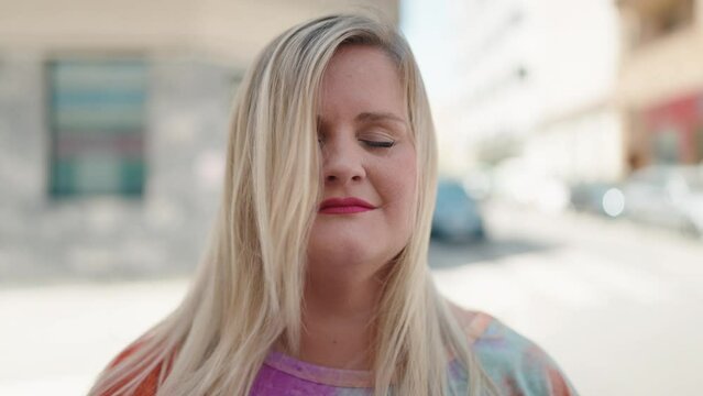 Young woman smiling confident standing at street