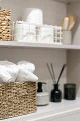 Clean bath towels on shelf in open closet storage