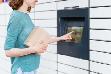 Woman confirm receive parcel in automatic post terminal
