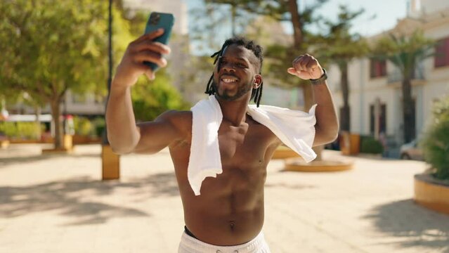 African american woman shirtless smiling confident make selfie by the smartphone at park
