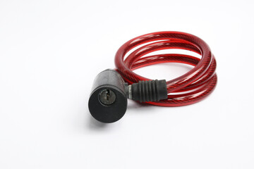 Naklejka premium flexible red cable padlock for bicycle safety when parking, isolated white background.