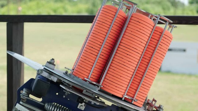 Slow Motion Clay Pigeon from the Side. Bench shooting on plates. V-log Bench shooting on plates. Automatic machine for throwing plates for shooting. Throwing machine for bench shooting.