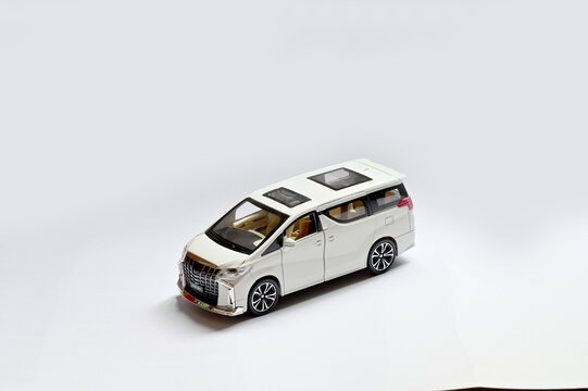 BANGKOK, THAILAND - July 17, 2022 : New Toy Car Model White Pearl Crystal Toyota Alphard Minivan  isolated on white background with shadow.