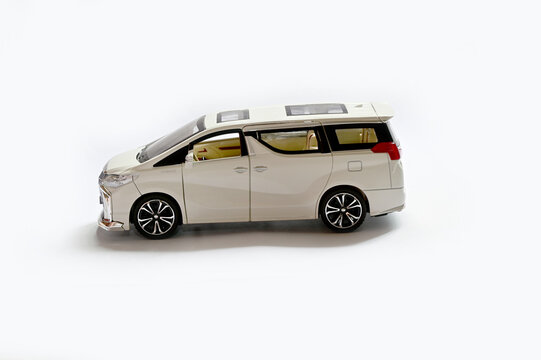 BANGKOK, THAILAND - July 17, 2022 : New Toy Car Model White Pearl Crystal Toyota Alphard Minivan  isolated on white background with shadow.