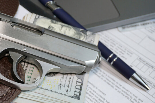 Small pistol and money in office environment