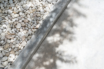 White pebble stone texture on the ground. The pebbles closely stone texture features