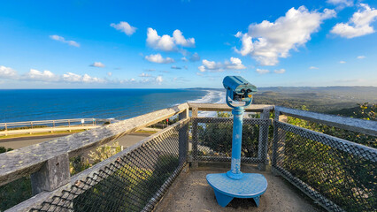 Public viewing binoculars on the headland at Cape Byron, Byron Bay tourist destination in Australia