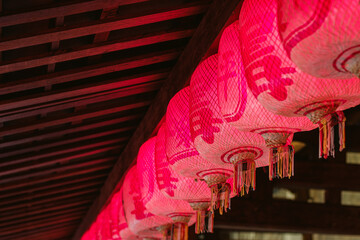 A row of Chinese red lanterns hang on the ceiling
