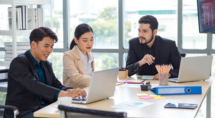 Group of millennial Asian Indian multinational multicultural male and female businessman businesswoman teamwork in formal suit sitting smiling brainstorming meeting together in office conference room