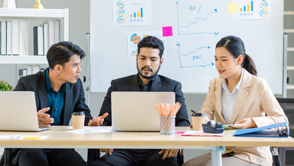 Group of millennial Asian Indian multinational multicultural male and female businessman businesswoman teamwork in formal suit sitting smiling brainstorming meeting together in office conference room