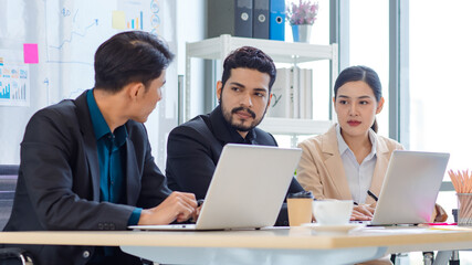Group of millennial Asian Indian multinational multicultural male and female businessman businesswoman teamwork in formal suit sitting smiling brainstorming meeting together in office conference room