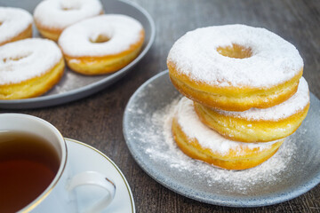 Donat kentang or potato donuts with a sprinkling of powdered sugar. donuts made of potatoes. have a sweet taste.has a soft texture