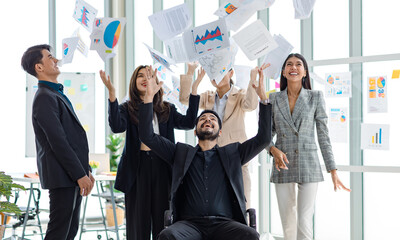 Millennial Asian Indian male female businessman businesswoman group in multinational multicultural company throwing paperwork documents in air celebrating job achievement deal done together in office