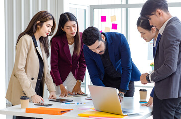 Millennial Indian Asian professional successful male female businessman businesswoman group in formal suit discussing brainstorming sharing business solution ideas in company conference meeting room