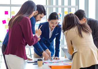 Millennial Indian Asian professional successful male female businessman businesswoman group in formal suit discussing brainstorming sharing business solution ideas in company conference meeting room