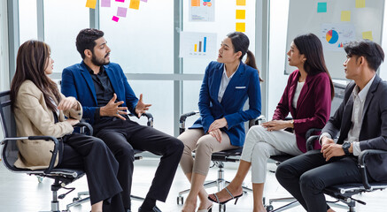 Millennial Indian Asian professional successful male female businessman businesswoman group in formal suit sitting together discussing brainstorming sharing business solution ideas in meeting room © Bangkok Click Studio