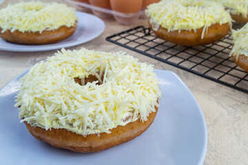 Donat ubi ungu or purple sweet potato donuts. made from purple sweet potato with a sprinkling of cheese on top. has a soft texture