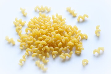 Pasta. Spiral macaroni. Raw uncooked macaroni isolated on white background, close up, top view.