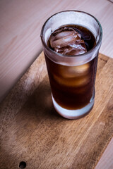 iced coffee on a wooden cutting board
