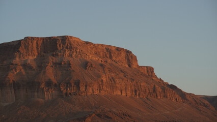 Fototapeta na wymiar Mountains near Dead Sea seashore at sunrise. Red mountains in the morning