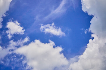 Naklejka na ściany i meble Beautiful big clouds slowly float across the summer blue sky.