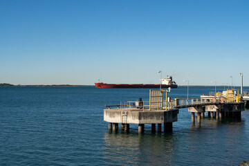 Bulk carrier ship passing the grain wharf at Gladstone heading into the harbour.