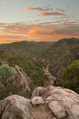 Peachy sunset sky at Crows Nest Falls in Queensland, Australia in the natural bush area. 
