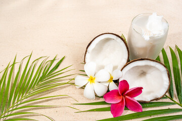 Coconut drink and coconut fruit on sand background.