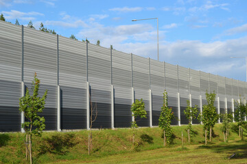 A noise barrier (also called a soundwall, noise wall, sound berm, sound barrier, or acoustical barrier) is an exterior structure designed to protection of people against noise.