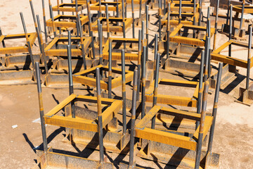 Building materials at a construction site. Prepared materials and embedded parts for foundations at a construction site. Formwork for grillages and foundations.