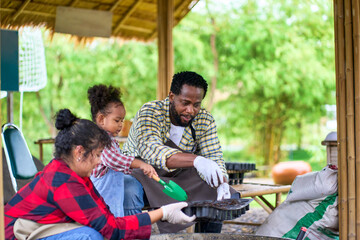 Mixed Fmaily working and take activity together on organic farm , Dad ,mom and daughter
