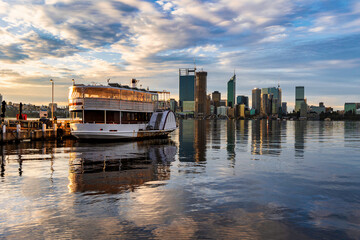 Cityscape Sunset, Perth, Western Australia, with paddle boat in foreground. July 2022