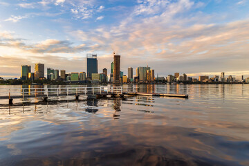 Sunset cityscape. Perth, Western Australia. July 2022. View of Perth from South Perth, with jetty in foreground. 