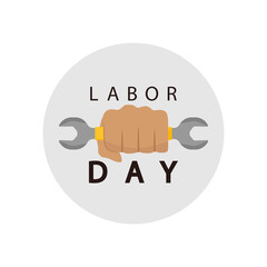 Labor day, fist holding a wrench on a light background.