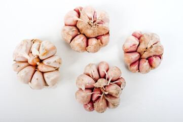 Several large heads of garlic, shot against a white background.
