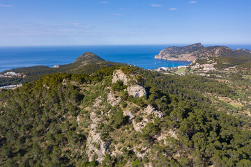 Fototapeta na wymiar Aerial view of cliffs on top of mountain in Peguera, Mallorca, Spain. Blue sea and Es Camp de Mar in background