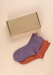 Children's colorful socks on a pink background