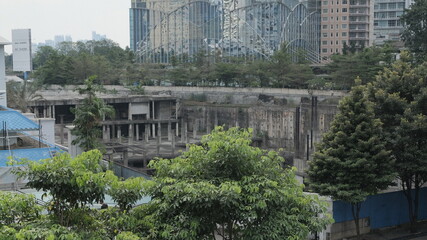 Fototapeta na wymiar Under contruction building from Pinnisi Bridge, taken on July 10, 2022 in Jakarta