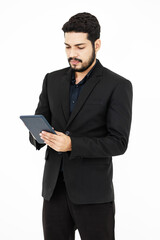 Portrait studio shot of Millennial Indian bearded male professional successful businessman ceo entrepreneur in formal suit standing on white background.