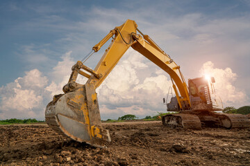 Backhoes or excavators work on parks or road constructions.